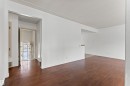 This interior space features dark wood floors and white walls - 8608 156 Street, Edmonton, AB  - Indoor Photo Showing Other Room 