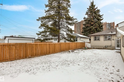 The property features a fenced yard with a wooden fence and a light-colored stucco exterior - 8608 156 Street, Edmonton, AB - Outdoor