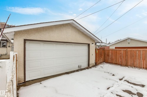 Detached garage with a white panel door and exterior lighting - 8608 156 Street, Edmonton, AB - Outdoor With Exterior