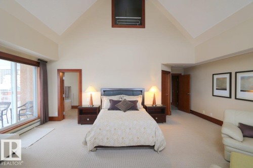 Bedroom featuring high vaulted ceiling and light colored carpet - 1402 9707 105 Street, Edmonton, AB - Indoor Photo Showing Bedroom