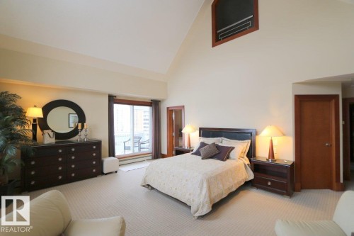 Bedroom featuring high vaulted ceiling and light carpet - 1402 9707 105 Street, Edmonton, AB - Indoor Photo Showing Bedroom