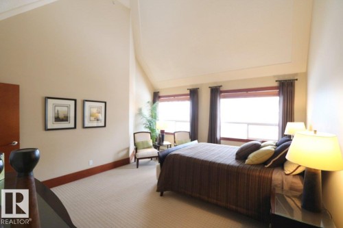Carpeted bedroom featuring high vaulted ceiling and baseboards - 1402 9707 105 Street, Edmonton, AB - Indoor Photo Showing Bedroom