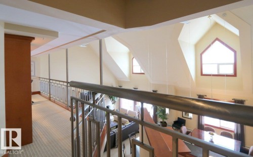 Hall with healthy amount of natural light, carpet flooring, and a high ceiling - 1402 9707 105 Street, Edmonton, AB - Indoor Photo Showing Other Room