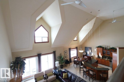 Living room featuring high vaulted ceiling and ceiling fan - 1402 9707 105 Street, Edmonton, AB - Indoor