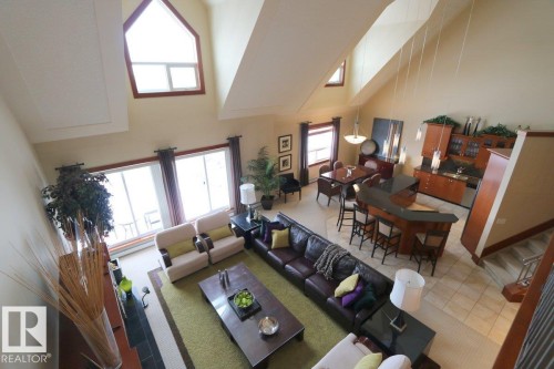 Living area with a high ceiling and light tile patterned flooring - 1402 9707 105 Street, Edmonton, AB - Indoor