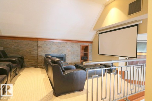 Cinema room with a fireplace and a wainscoted wall - 1402 9707 105 Street, Edmonton, AB - Indoor With Fireplace