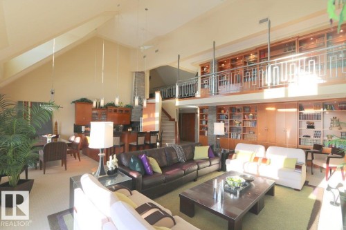 Living room featuring high vaulted ceiling, stairway, and carpet flooring - 1402 9707 105 Street, Edmonton, AB - Indoor Photo Showing Living Room