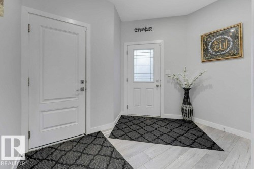 Entryway featuring light-colored flooring, white walls, and two white doors - 452 Roberts Crescent, Leduc, AB - Indoor Photo Showing Other Room