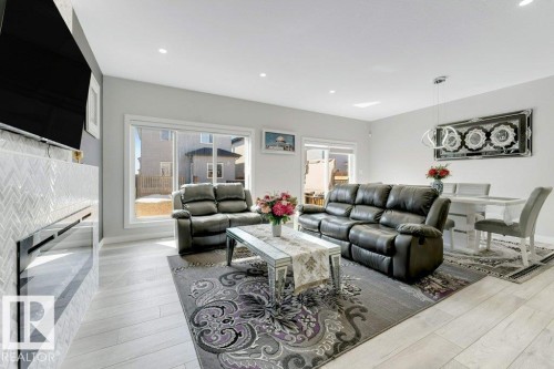 Bright and spacious living area with light-colored flooring, recessed lighting, and large windows - 452 Roberts Crescent, Leduc, AB - Indoor Photo Showing Living Room