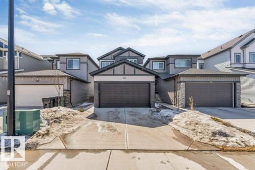 The property features a contemporary exterior with gray siding and stone accents - 452 Roberts Crescent, Leduc, AB - Outdoor With Facade