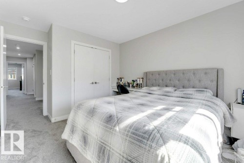Bedroom featuring light-colored walls, grey carpeting, and white double-door closets - 452 Roberts Crescent, Leduc, AB - Indoor Photo Showing Bedroom