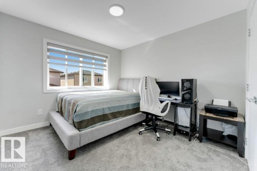 This room features light grey walls and light grey carpet, with a window providing natural light - 452 Roberts Crescent, Leduc, AB - Indoor Photo Showing Bedroom
