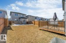 The property features a backyard with a wooden deck and a privacy fence - 452 Roberts Crescent, Leduc, AB  - Outdoor With Exterior 
