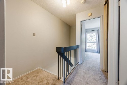 Upper level landing. This level features 2 large bedrooms with newer plush carpeting and a renovated 4-pce bath. - 12032 25 Avenue, Edmonton, AB - Indoor Photo Showing Other Room