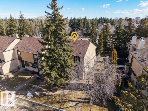 The property features a brown shingle roof and a light-colored exterior - 12032 25 Avenue, Edmonton, AB - Outdoor