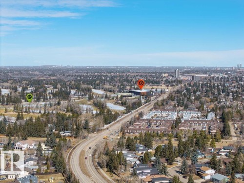 The property offers expansive views of the surrounding urban landscape, featuring a golf course, residential areas, and a thoroughfare - 12032 25 Avenue, Edmonton, AB - Outdoor With View
