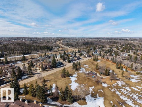 Aerial view of the community, featuring residential properties, roads, and extensive green spaces with scattered trees - 12032 25 Avenue, Edmonton, AB - Outdoor With View
