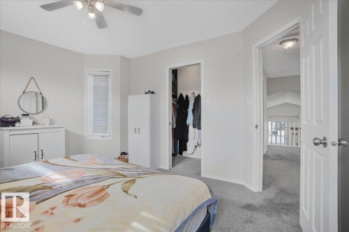 Bedroom with light gray walls, a window with blinds, and a ceiling fan with light fixture - 3119 32 Avenue, Edmonton, AB - Indoor Photo Showing Bedroom