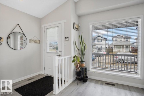Entryway featuring light-colored walls and a window with horizontal blinds - 3119 32 Avenue, Edmonton, AB - Indoor Photo Showing Other Room