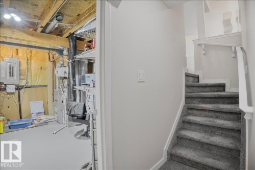 Carpeted staircase with white handrail leading to an upper level - 3119 32 Avenue, Edmonton, AB - Indoor