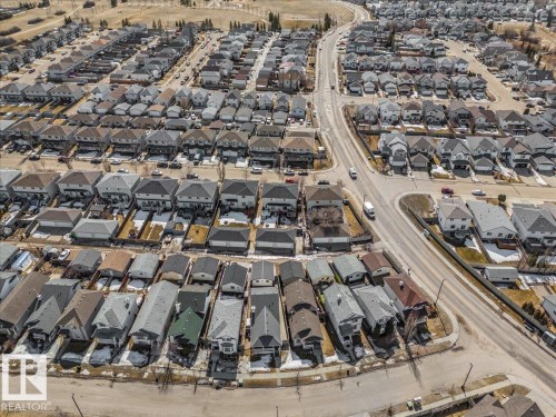 An aerial view showcases the property within a well-established residential area, featuring an extensive network of roads and numerous houses with varied rooflines - 3119 32 Avenue, Edmonton, AB - Outdoor With View
