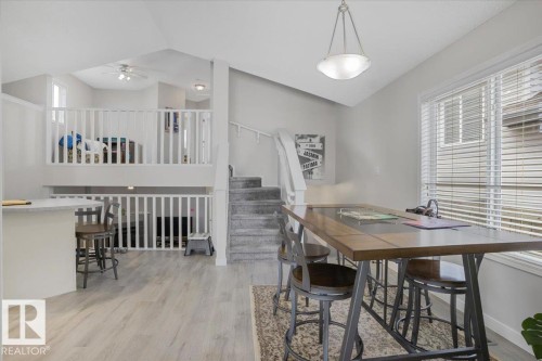 The property features light-toned flooring, a light gray wall color, and white railings - 3119 32 Avenue, Edmonton, AB - Indoor Photo Showing Dining Room