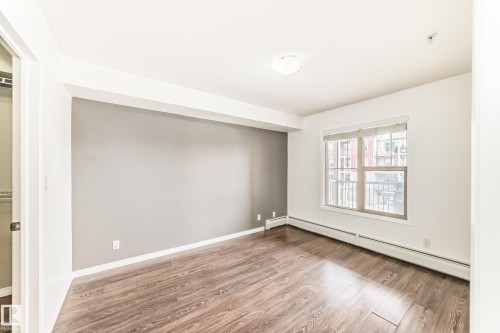This room features wood plank flooring and a window with blinds - 301 103 Ambleside Drive, Edmonton, AB - Indoor Photo Showing Other Room