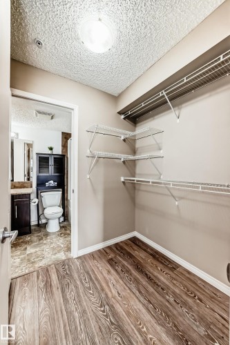 Spacious closet with wire shelving and durable wood-look flooring - 301 103 Ambleside Drive, Edmonton, AB - Indoor With Storage