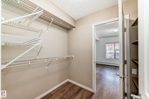 Closet featuring wire shelving and wood-style flooring - 301 103 Ambleside Drive, Edmonton, AB - Indoor With Storage