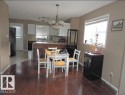 The property features an open layout with rich hardwood flooring - 1318 8 Avenue, Cold Lake, AB  - Indoor Photo Showing Dining Room 