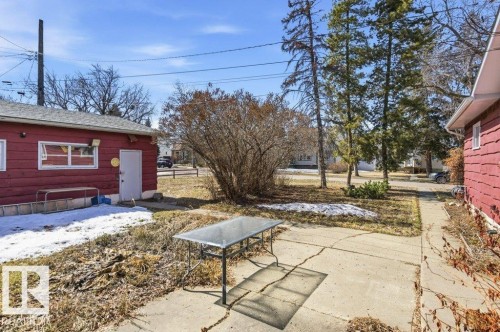 The property includes a red exterior building with white trim, a white door, and windows - 10459 66 Avenue, Edmonton, AB - Outdoor