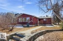 The property features a red exterior, large front windows, and a concrete pathway leading to the entrance - 10459 66 Avenue, Edmonton, AB  - Outdoor 