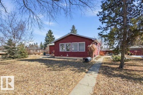 The property features a red exterior with white trim windows and a concrete pathway leading to the entrance - 10459 66 Avenue, Edmonton, AB - Outdoor