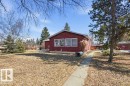 The property features a red exterior with white trim windows and a concrete pathway leading to the entrance - 10459 66 Avenue, Edmonton, AB  - Outdoor 