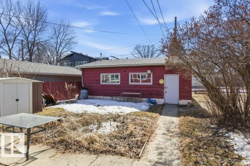 The property includes a detached red outbuilding with a white door and two windows - 10459 66 Avenue, Edmonton, AB - Outdoor