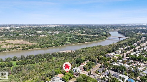 The property is situated in a well-established community, offering views of the river and surrounding green spaces - 8028 Rowland Road, Edmonton, AB 