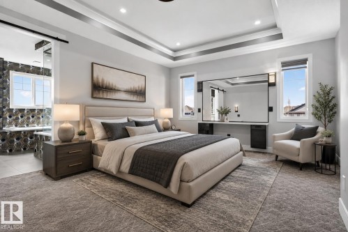 Spacious room featuring tray ceilings, recessed lighting, and large windows with privacy blinds - 707 180 Street, Edmonton, AB - Indoor Photo Showing Bedroom