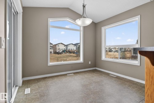This room features tile flooring, neutral wall colors, and a ceiling light fixture - 96 Dalquist Bay, Leduc, AB - Indoor Photo Showing Other Room