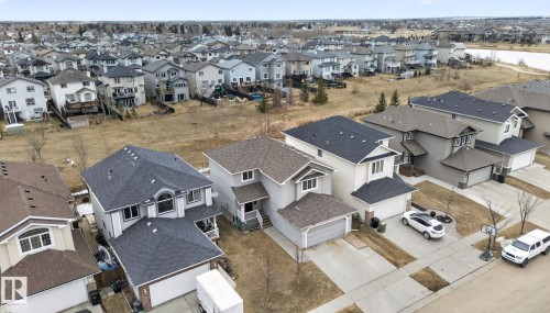 Aerial view showcasing the property's exterior, including a driveway and an attached garage - 96 Dalquist Bay, Leduc, AB - Outdoor