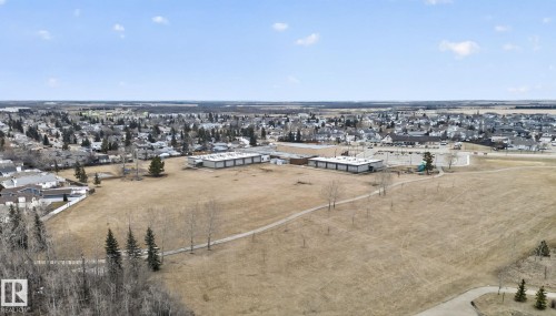 Aerial view showcasing the surrounding neighbourhood with residential properties and open green spaces - 96 Dalquist Bay, Leduc, AB - Outdoor With View
