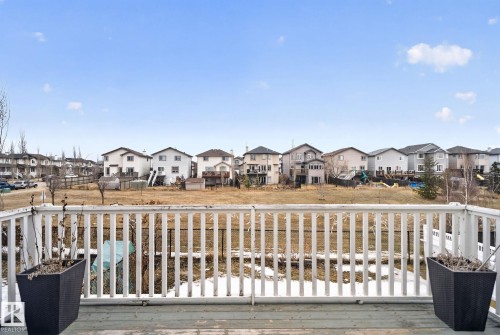 A private deck with a white railing overlooks the surrounding properties - 96 Dalquist Bay, Leduc, AB - Outdoor