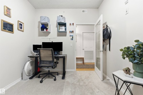 This room features light-colored carpeting, white walls, and a glass-paneled door - 316 141 Festival Way, Sherwood Park, AB - Indoor Photo Showing Office