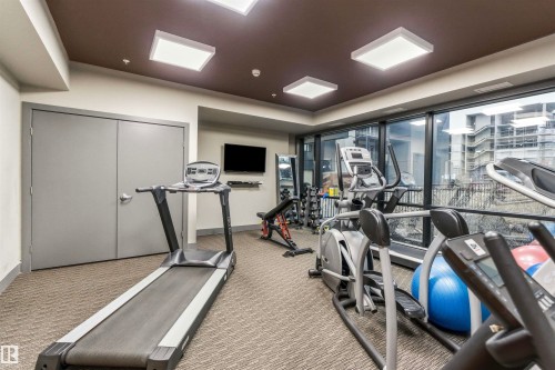 Fitness area with various exercise equipment and large windows offering exterior views - 316 141 Festival Way, Sherwood Park, AB - Indoor Photo Showing Gym Room