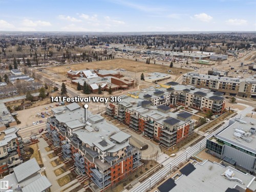 Aerial view of the property and its surrounding environment, featuring multi-story residential buildings with balconies and commercial structures in the distance - 316 141 Festival Way, Sherwood Park, AB - Outdoor With View