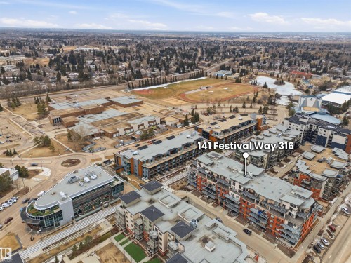 Aerial view showcasing the property's location within a developed area, surrounded by various buildings and green spaces - 316 141 Festival Way, Sherwood Park, AB - Outdoor With View