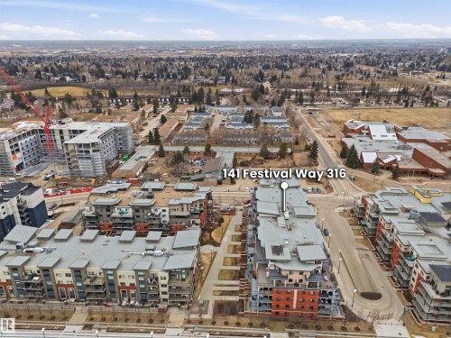 Aerial view showcasing the property's location within the community, featuring surrounding buildings and green spaces - 316 141 Festival Way, Sherwood Park, AB - Outdoor With View