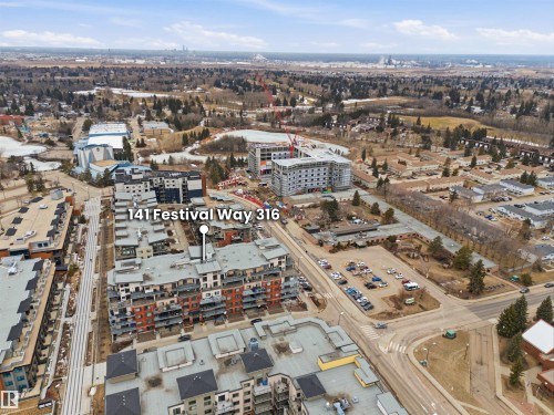 Aerial view of the building and surrounding area, featuring paved roads and various structures - 316 141 Festival Way, Sherwood Park, AB - Outdoor With View