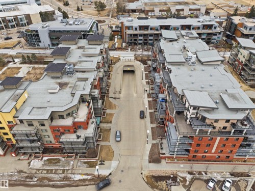 Aerial view showcasing the property's modern architectural design with multi-story buildings, flat roofs, and a mix of brick and paneling on the facades - 316 141 Festival Way, Sherwood Park, AB - Outdoor With View