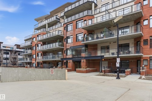 The property is a contemporary multi-story building featuring a brick facade, numerous balconies with glass railings, and a prominent main entrance with a large overhang - 316 141 Festival Way, Sherwood Park, AB - Outdoor With Balcony With Facade