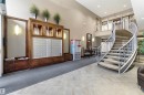 Entryway featuring a decorative spiral staircase, a mail station, and light-colored tile flooring - 316 141 Festival Way, Sherwood Park, AB  - Indoor Photo Showing Other Room 